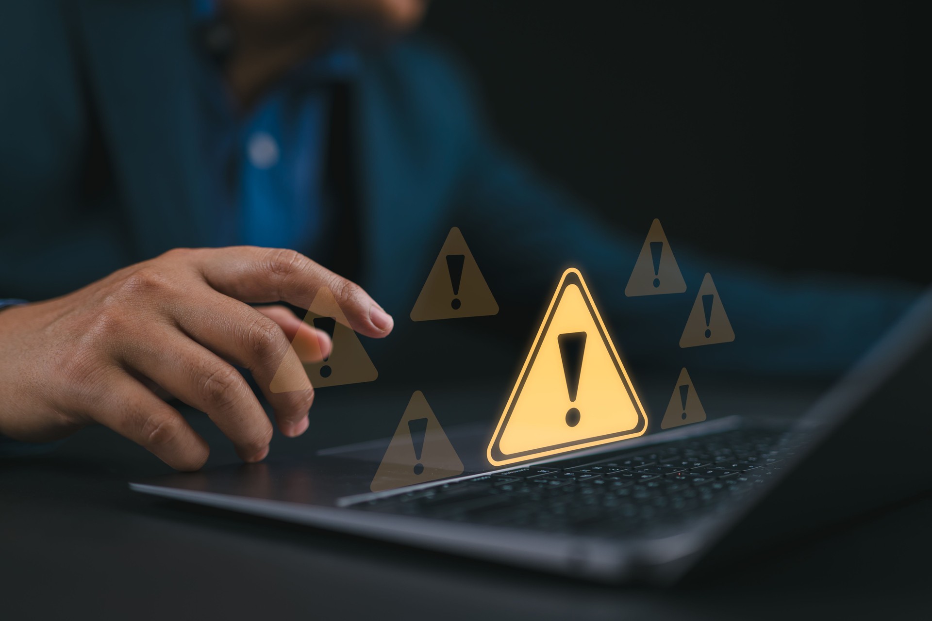 System hacked warning alert. Ransomware, Virus, Spyware, Malware or Malicious software, Data breach, Cyber security and cybercrime. Businessman use laptop with warning sign for cyber attack.